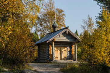 A beautiful wooden chapel at the Solovki cemetery. Chapel of All Saints in the autumn forest. Russia, Solovetsky Islands 