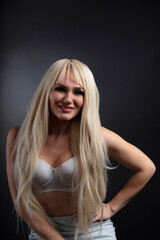 Naklejka premium Fashionable photo of young blonde woman wearing white lingerie 