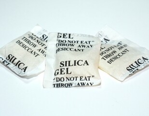 Paper packets of silica gel. Desiccant silica gel on white background. Synthetic substance absorbing moisture. Humidity control