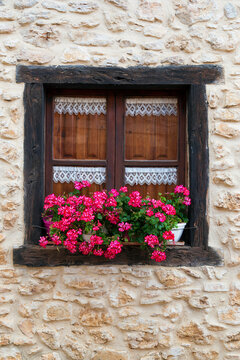 Window of an ancient house decorated with flowers