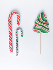 Kit of three Christmas candies. Lollipop in Christmas tree form. Red, green and white spiral stripes.
