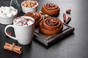 Freshly baked cinnamon roll with spices and cocoa filling on a black background