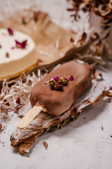 Homemade chocolate popsicle lay on wood for decor, gray marble background,