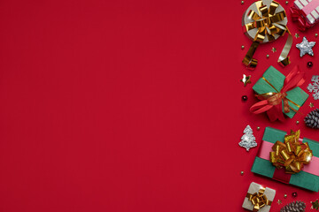 Fototapeta na wymiar Christmas pattern made of holiday accessories on red background. Preparation for Christmas Eve