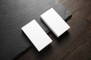 Photo of two stacks of blank business cards on stone board background.
