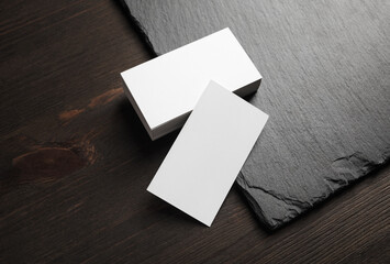 Blank white business cards on stone board background. Copy space.