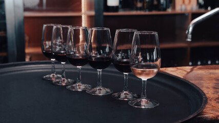 wine glasses on tray at bar