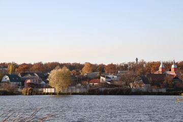 Fototapeta premium Village with church at the lake