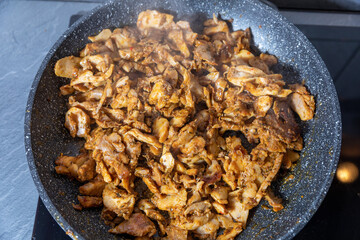 cooking chicken gyros in a pan
