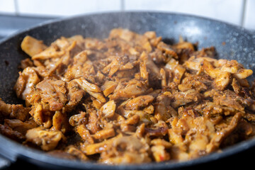 cooking chicken gyros in a pan