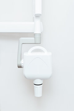 white dental x-ray machine on wall background