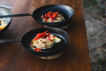 Provolone cheese, red peppers and onions. Ready dish served in a hot pan. Suggestion of serving the dish.