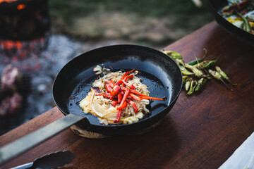 Provolone cheese, red peppers and onions. Ready dish served in a hot pan. Suggestion of serving the dish.