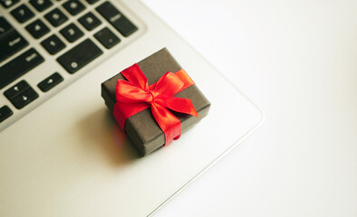 Holiday's shopping concept. Gift box on laptop. Online sale. Birthday wish list buying 