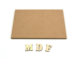 Raw MDF board, with an inscription of wooden letters under the MDF board.