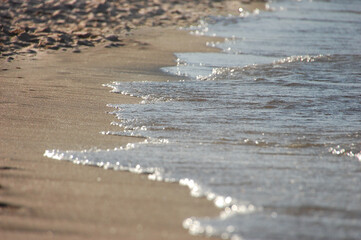 Close up blue sea water waves on sand beach