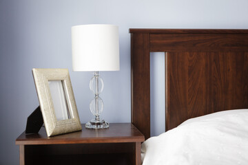 Bedroom, bedside table with lamp and picture frame