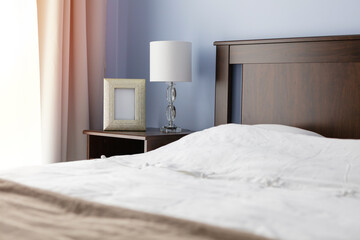 Bedroom, bedside table with lamp and picture frame