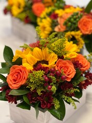 Fall flower decorations and centerpiece across the table in orange, yellow and red