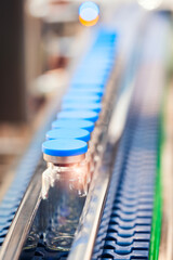 Glass bottles in production in the tray of an automatic liquid dispenser, a line for filling...