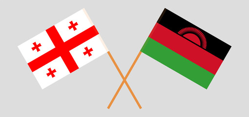 Crossed flags of Georgia and Malawi. Official colors. Correct proportion