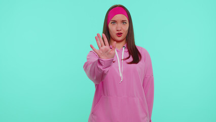 No Stop. Stylish adult girl say no hold palm folded crossed hands in stop danger gesture, warning of finish, prohibited access, declining communication, body language. Young woman on blue background