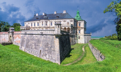 Ancient Pidhirtsi castle and rural summer landscape