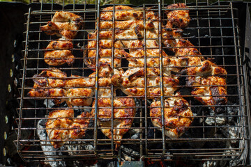 Chicken fried on the grill, shish kebab from pieces of chicken meat barbecue top view