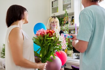 Parents congratulating teenage daughter with happy birthday