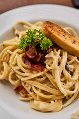 Spagheti carbonara with bacon and toast bread