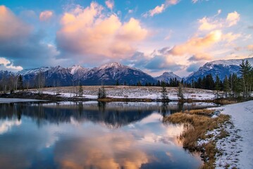 Sunrise Clouds Over A Snowy Quarry Lake