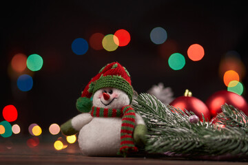 funny snowman on a Christmas evening background.