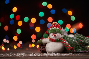 cute funny snowman on Christmas evening background.