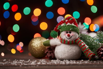 cute funny snowman on Christmas evening background.