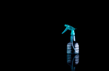 Plastic bottle for spray on black background.