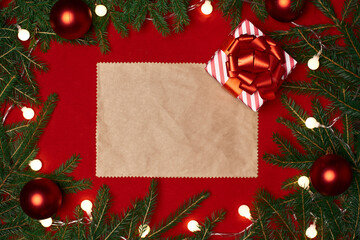 Fototapeta na wymiar blank sheet of paper and a Christmas gift and on a red festive background.