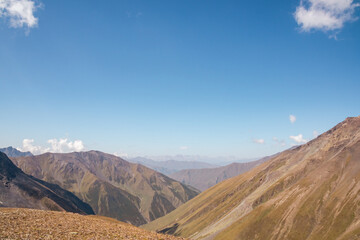 Panoramic view on a mountain chain seen from the Chaukhi Pass in the Greater Caucasus Mountain Range in Georgia, Kazbegi Region. The trail connects the villages of Juta and Roshka. Peak Sosuptano