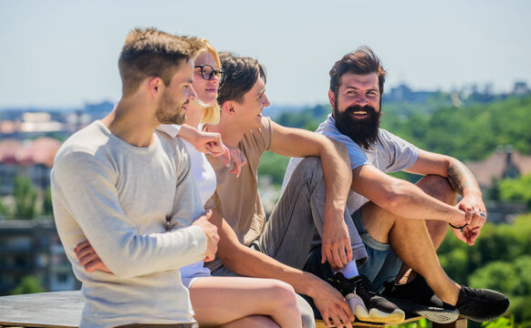 Free time. best friends. Summer vacation. happy men and girl relax. diverse young people talking together. group of four people. great fit for day off. Group of people in casual wear