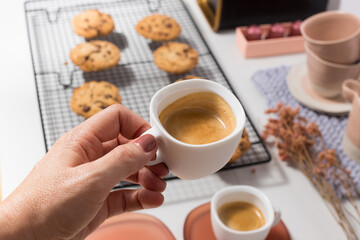 Well cared woman hand with perfect painted nails taking a delicious foamy cup of coffee.