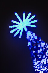 abstract bokeh effect on blue christmas tree with star