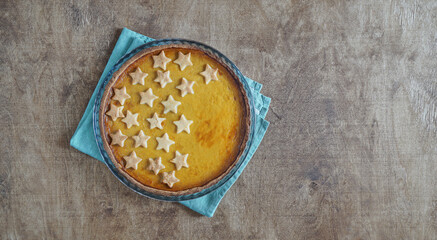 fresh homemade pumpkin pie on rustic wooden table. top view