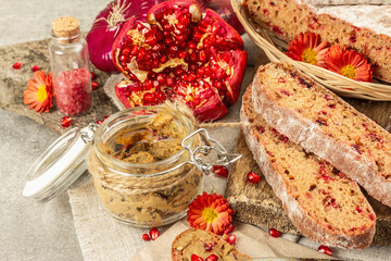 Fresh homemade chicken liver pate or paste in a glass jar with baguette slices on the serving board