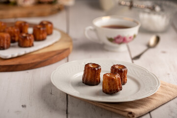 Bordeaux caneles on a plate with tea