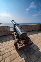 Old cannon in Dubrovnik. Vintage war weapon for defense and protection. Medieval fort in Dubrovnik protected by guns.