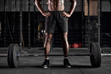 Fototapeta na wymiar sport, bodybuilding, lifestyle and people concept. cropped young black african american man with barbell is going to flex warm up muscles, powerlifter is engaged in bodybuilding cross fit.