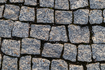Cobblestone background from the sidewalk made of small stones