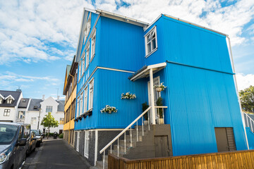 Colourful residential building along a street on a partly cloudy summer day. Reykjavik, Iceland. - obrazy, fototapety, plakaty