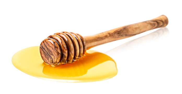 Wooden honey stick with honey drop isolated on white background