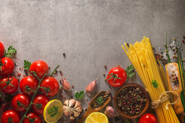 Italian food background on stone table. Macaroni, basil and vegetables.