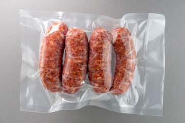 Italian salamella sausage in vacuum packed sealed for sous vide cooking isolated on grey background...